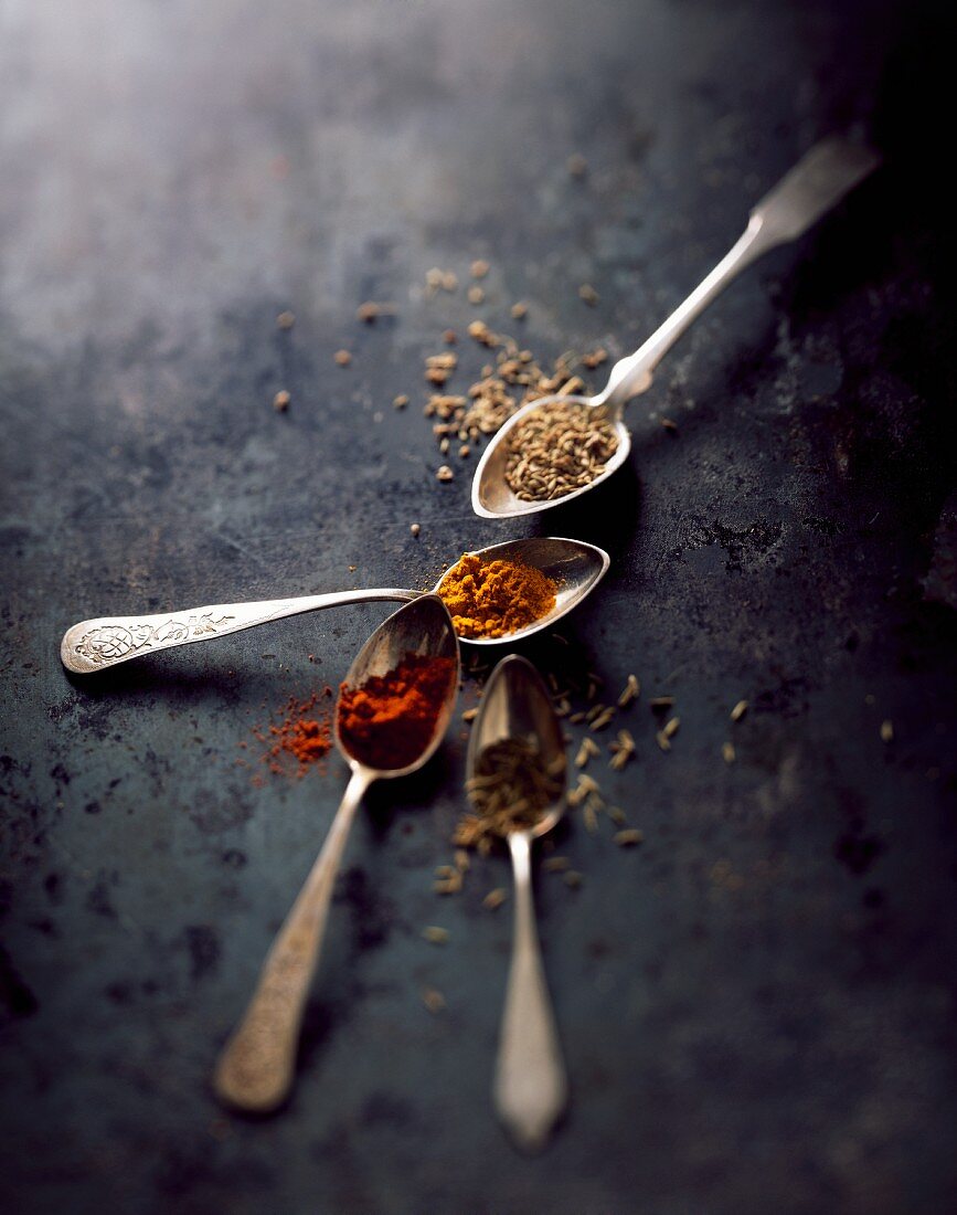Oriental spices on four spoons