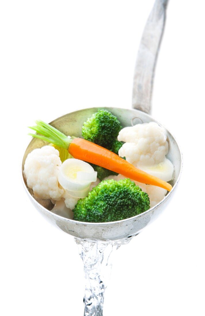 Blanched soup vegetables in a ladle