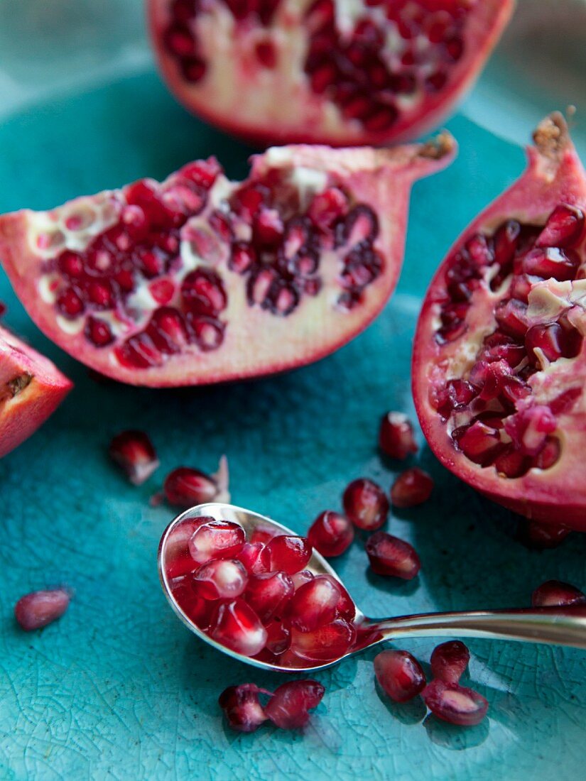 Sliced pomegranates and pomegranate seeds