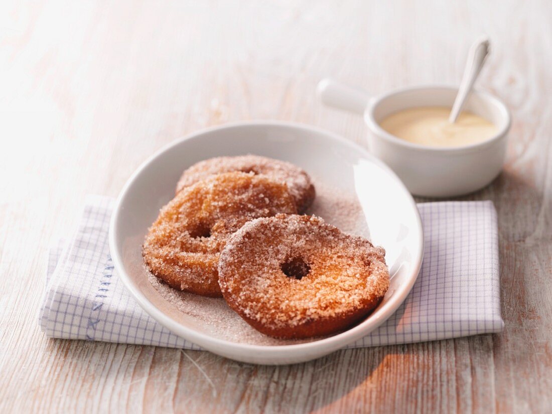 Apple cakes with cinnamon sugar and vanilla sauce