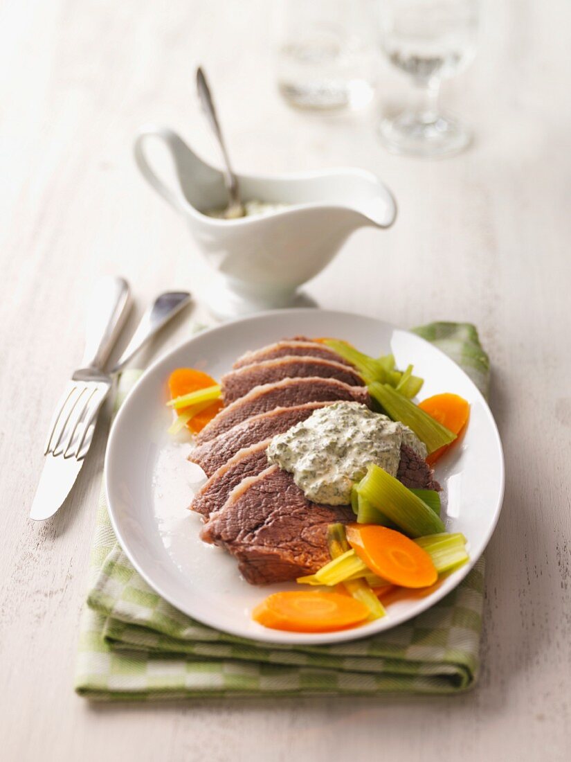 Cooked beef with green sauce and vegetables
