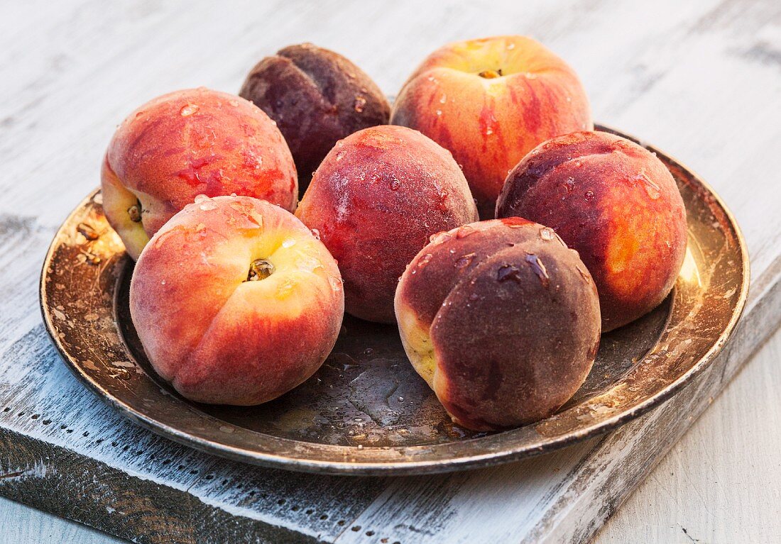 Fresh peaches on a metal plate