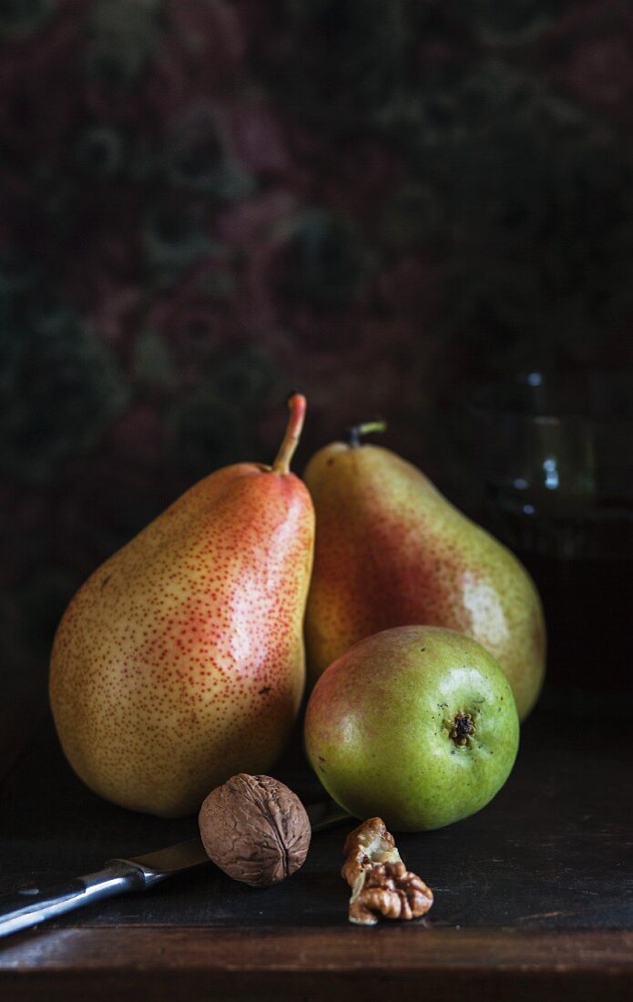 An autumnal arrangement with pears and walnuts