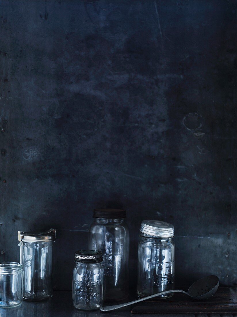 Preserving jars against a grey wall