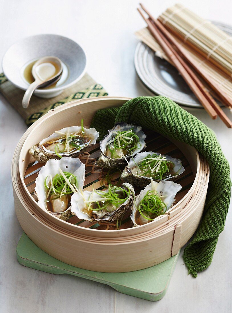 Steamed oysters in a bamboo steamer