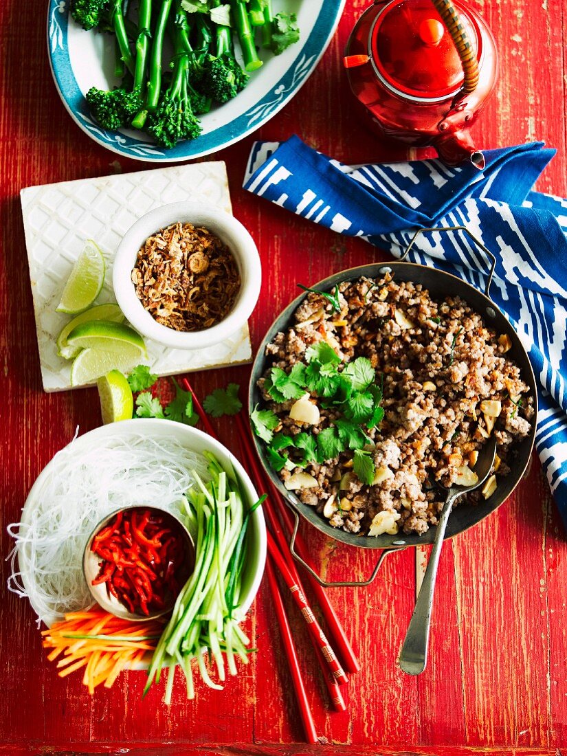 Minced pork with a honey-soy sauce served with a side of vegetables and tea (Thailand)