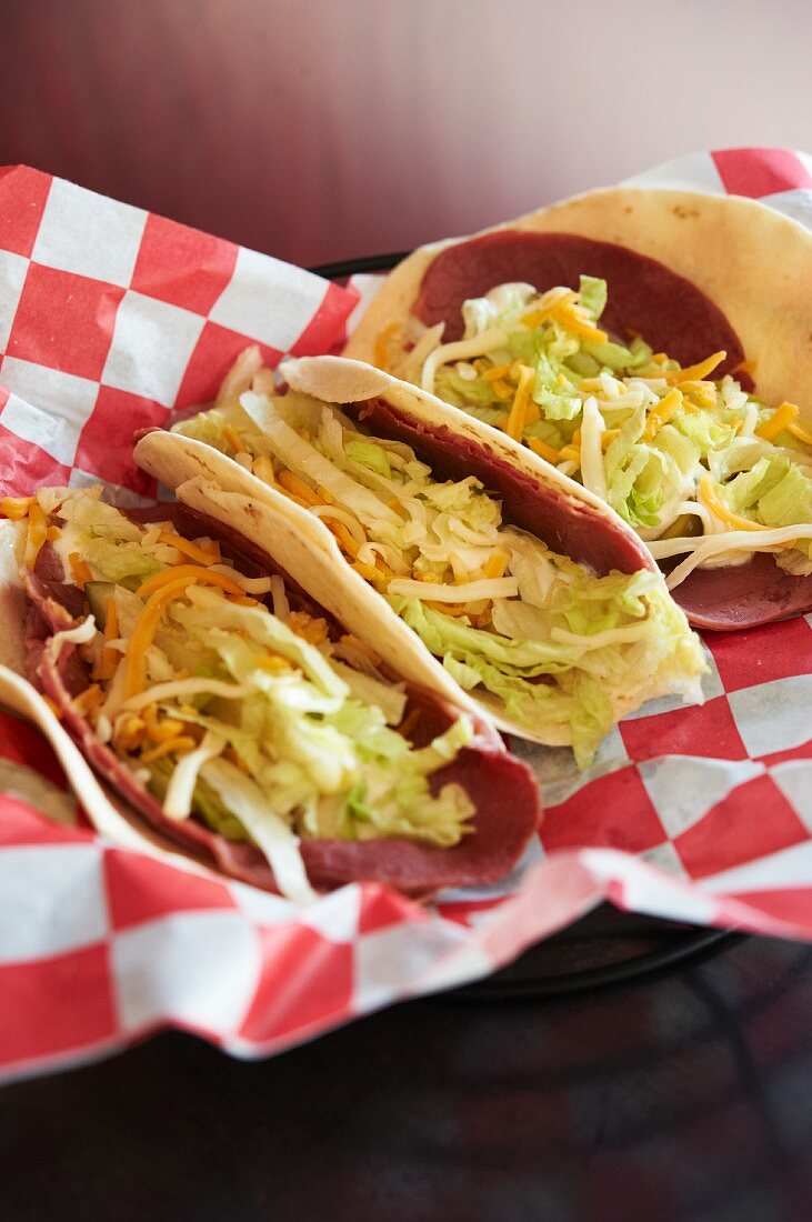 Three Corned Beef Tacos on Checkered Paper