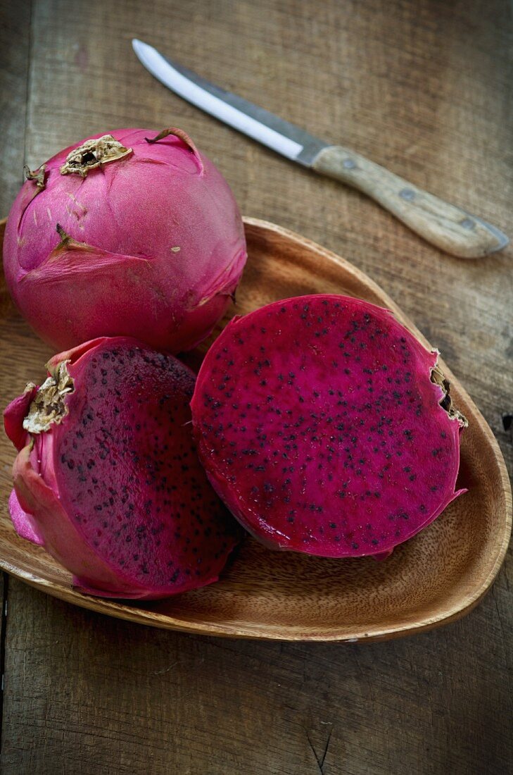 Red dragonfruits, whole and halved