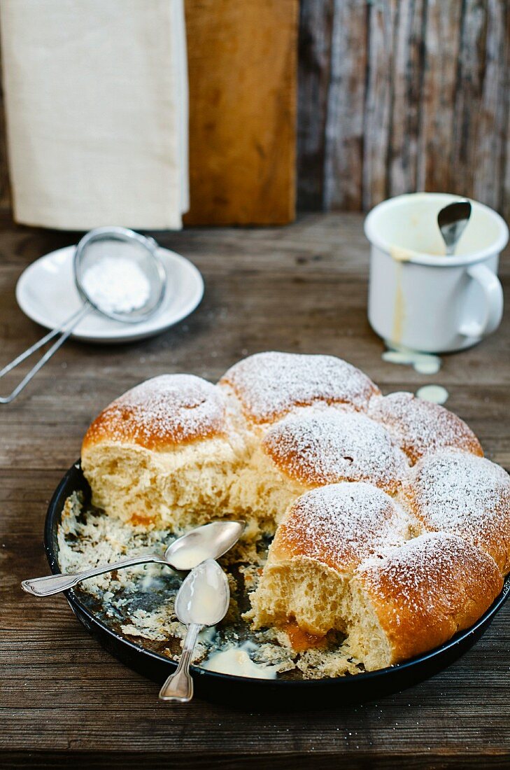 Buchteln (baked, sweet yeast dumpling) with apricot preserve and vanilla sauce