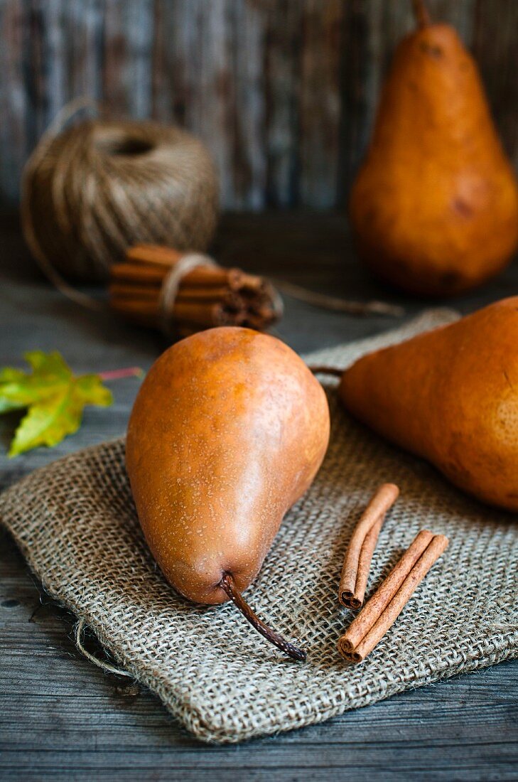 Kaiser pears and cinnamon sticks on a jute sack