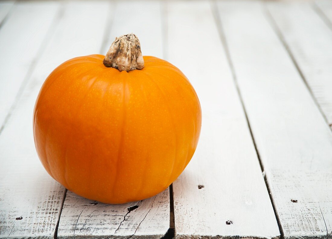 A pumpkin on a wooden table