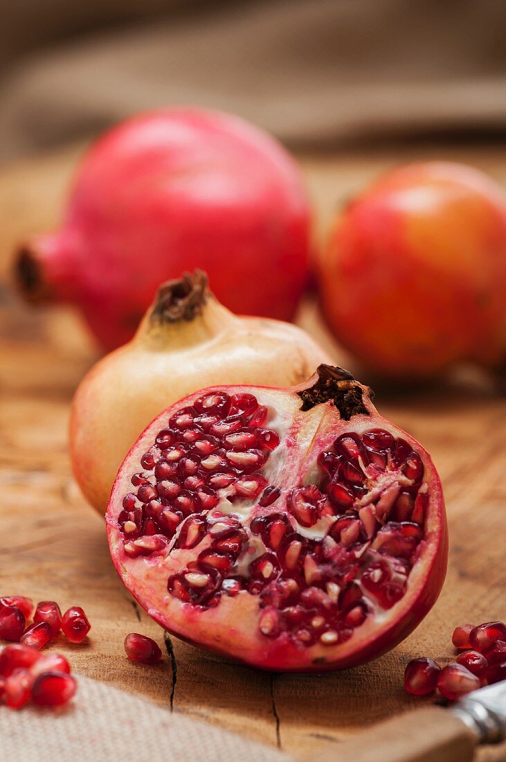 Pomegranates, whole and halved with seeds