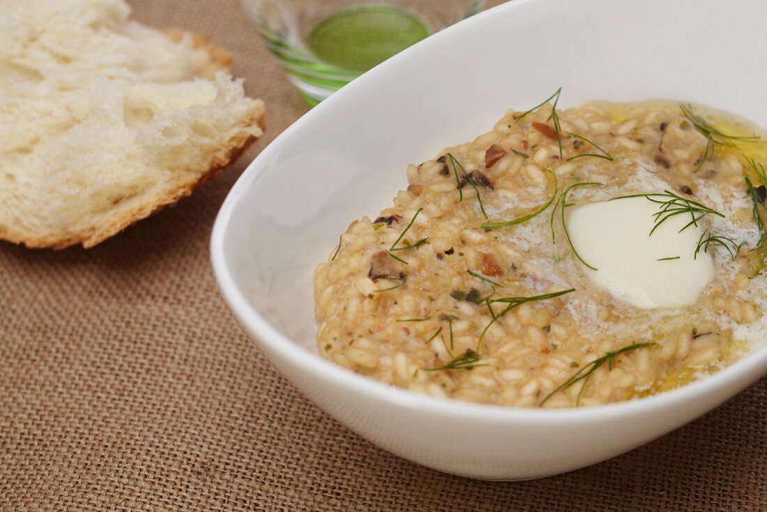 Butter Melting on Wild Mushroom and Herb Risotto; Bread