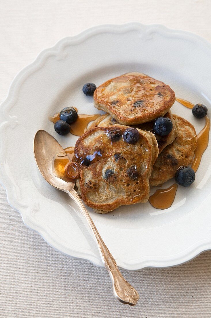 Blueberry Pancakes with Maple Syrup on a White Plate with a Spoon