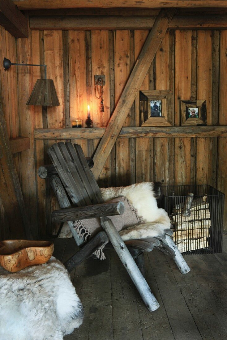 Animal-skin rug on rustic wooden chair in wooden cabin