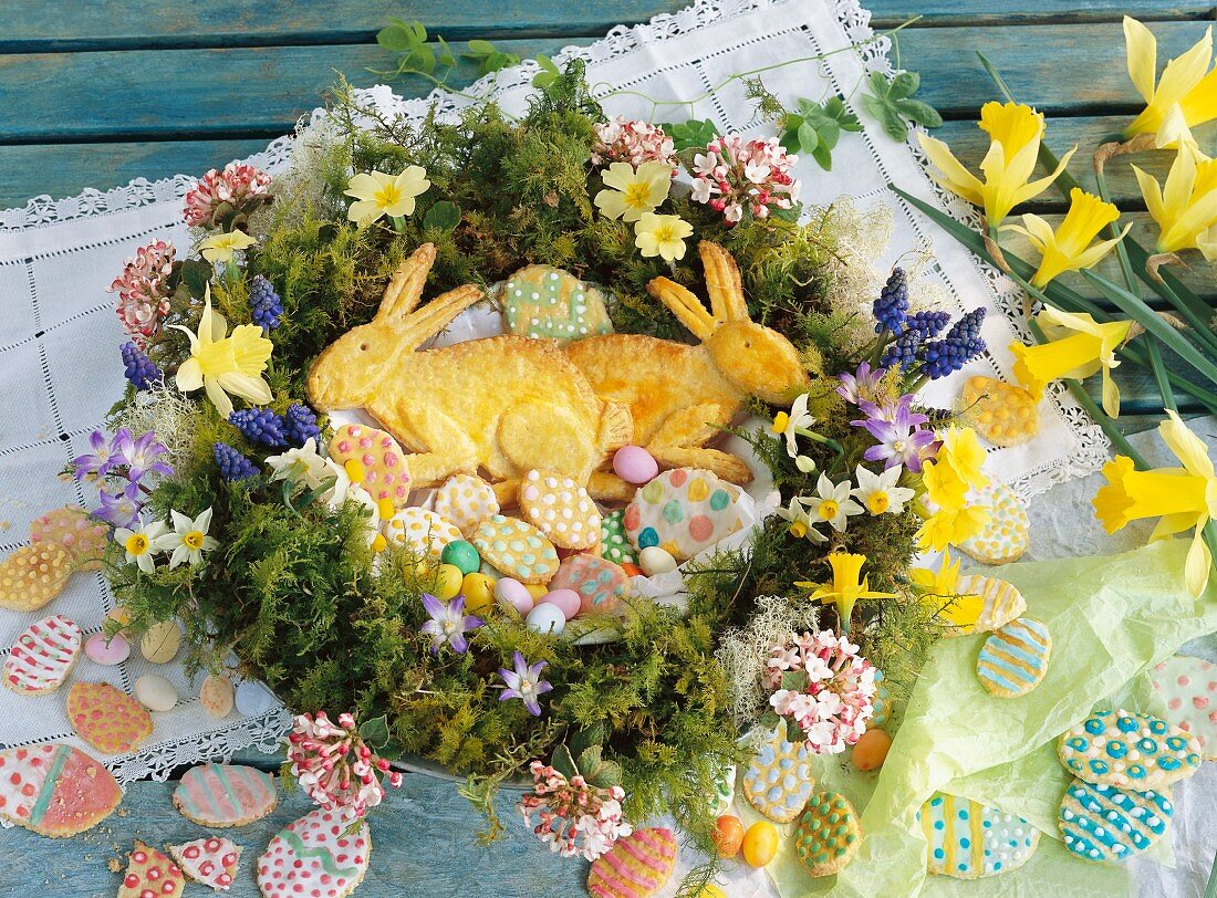 An Easter wreath with Easter bunnies, Easter eggs, Easter biscuits and daffodils