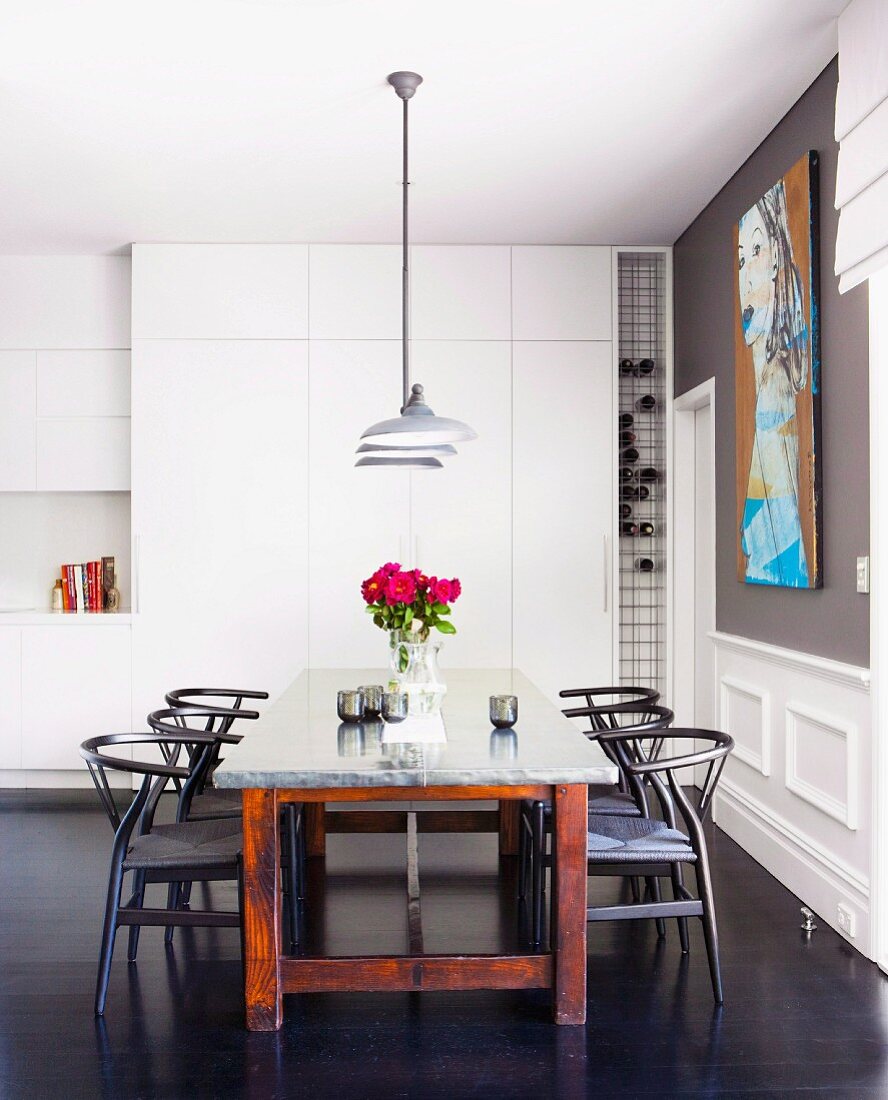 Dark wood, classic chairs at dining table in modern kitchen with traditional ambiance