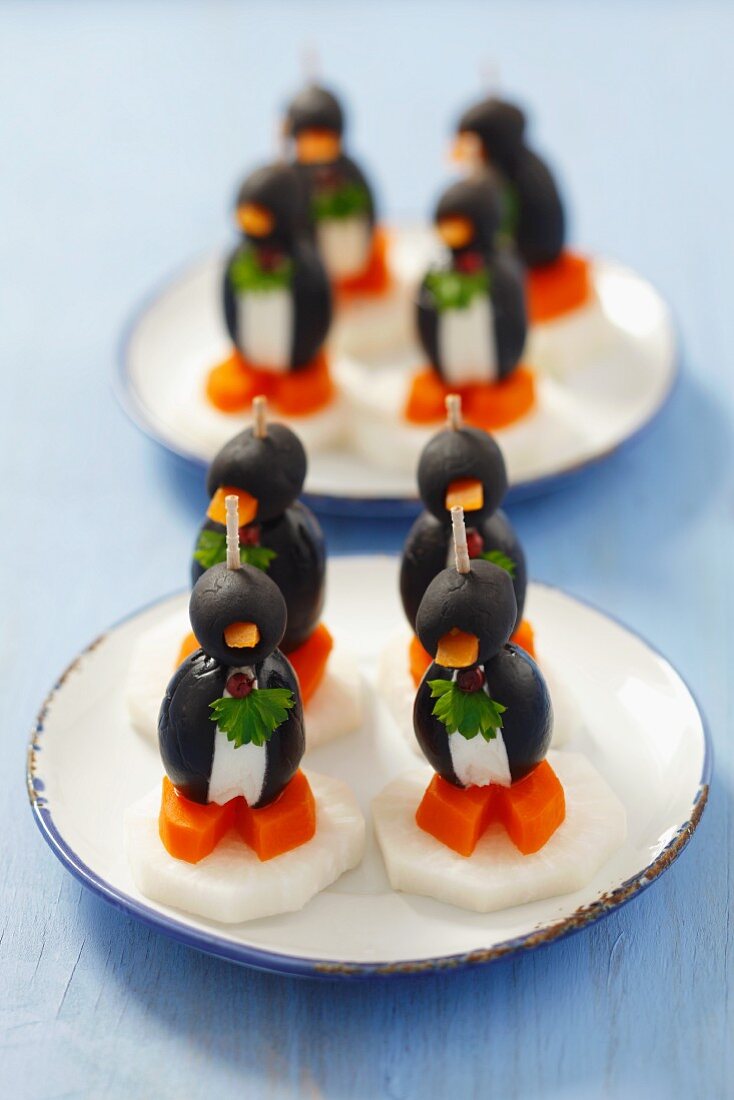 Olive penguins with cream cheese, carrots and radishes