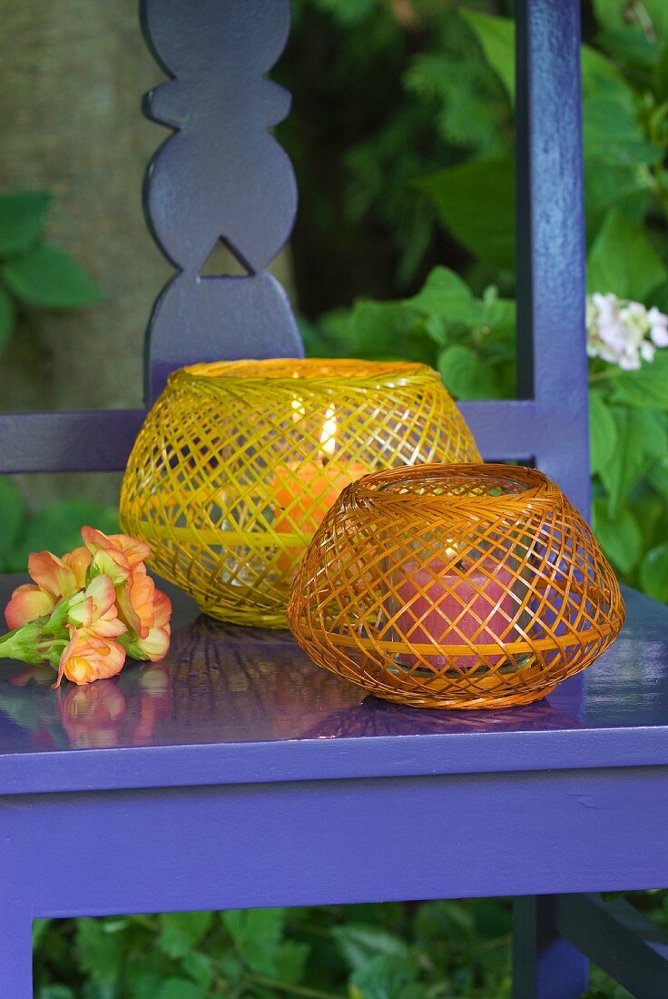 Wickerwork candle lanterns on blue-painted wooden chair