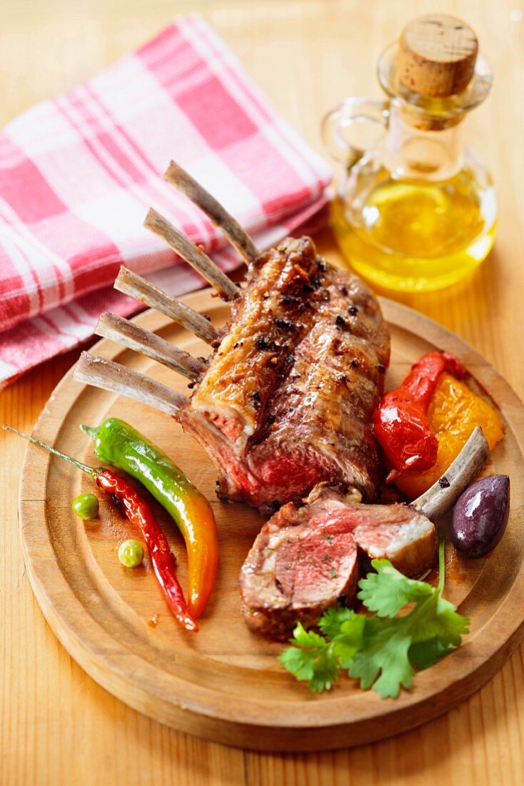 Grilled rack of beef with peppers on a wooden board