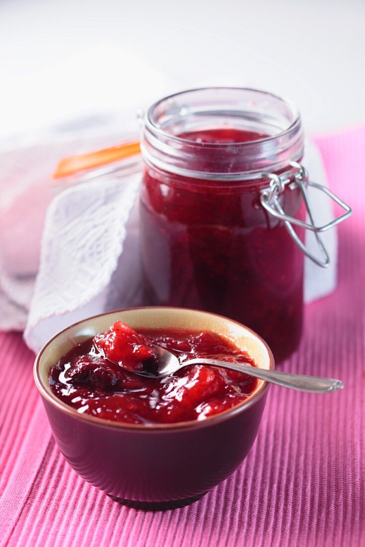 Strawberry jam in a bowl and in the jam jar