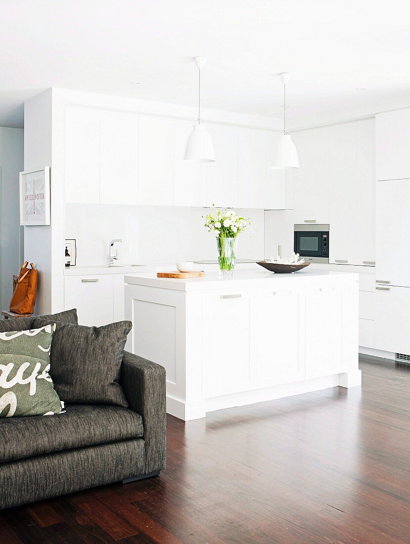 White, open-plan kitchen with island counter