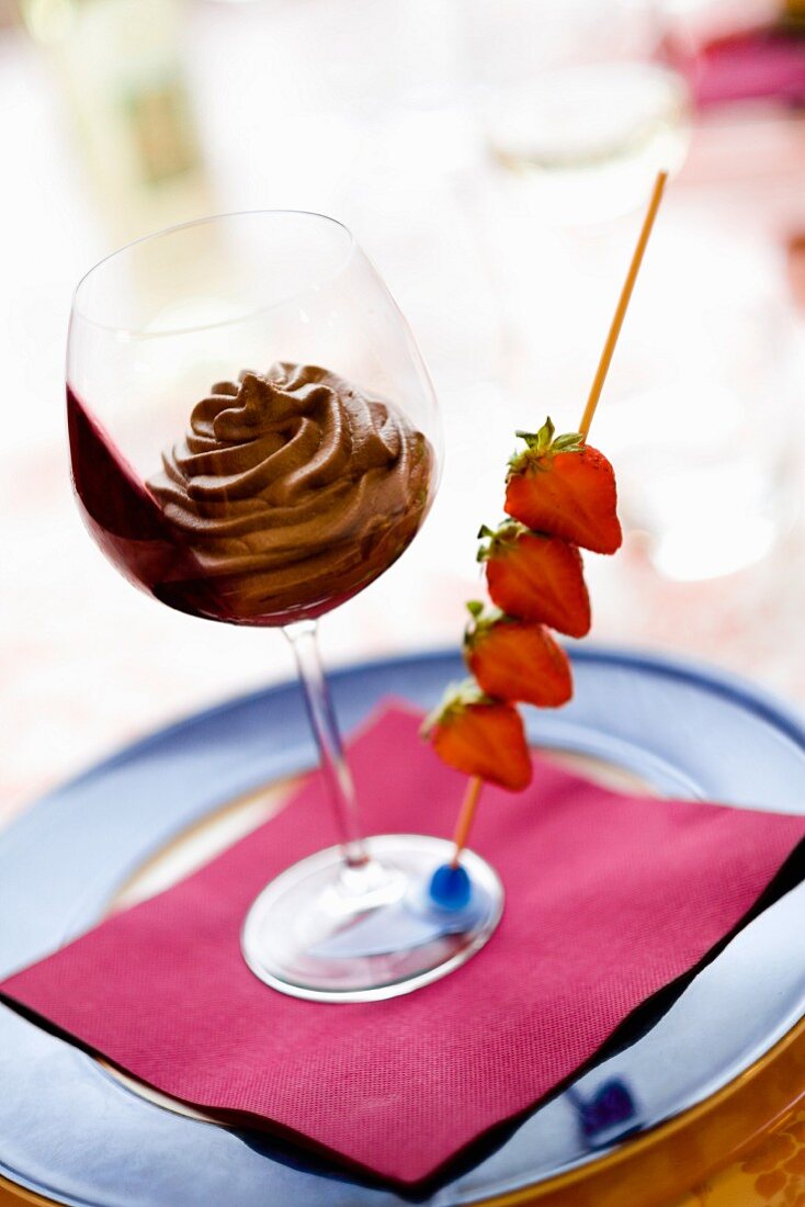 Chocolate mousse with a skewer of strawberries