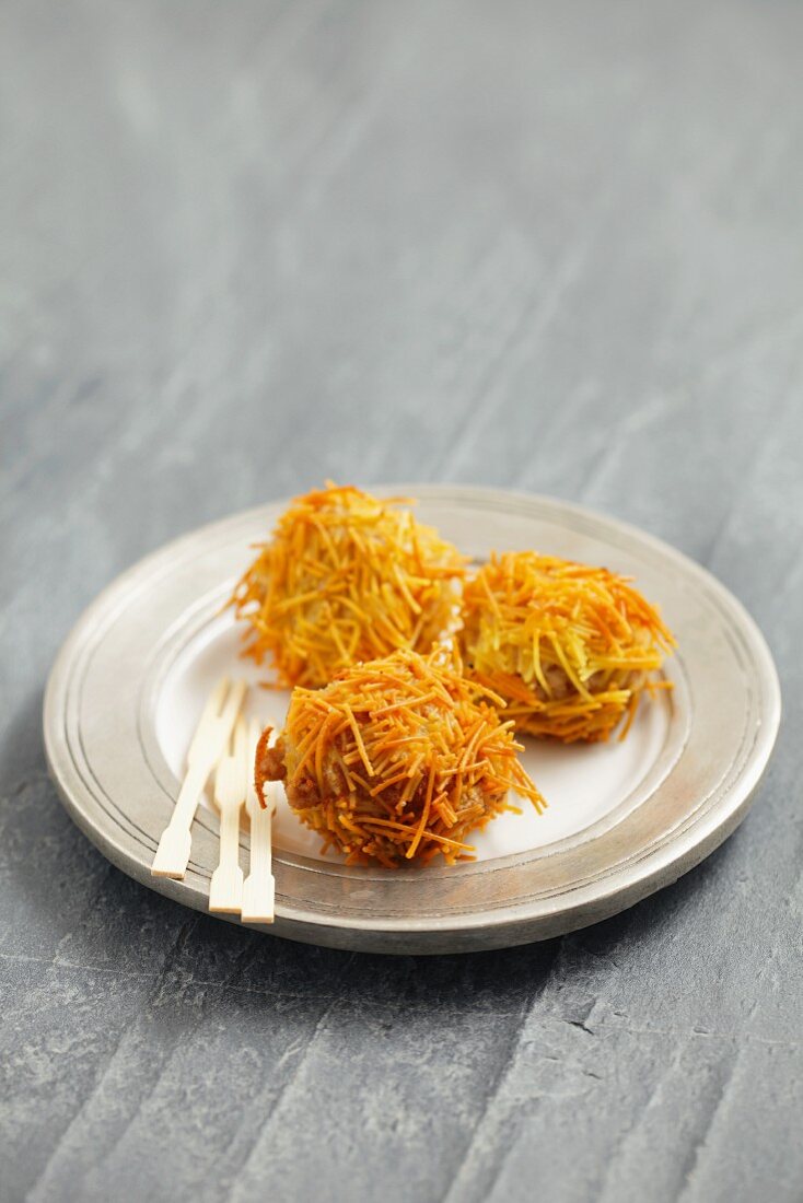 Spheres of goose liver with deep-fried angel hair pasta