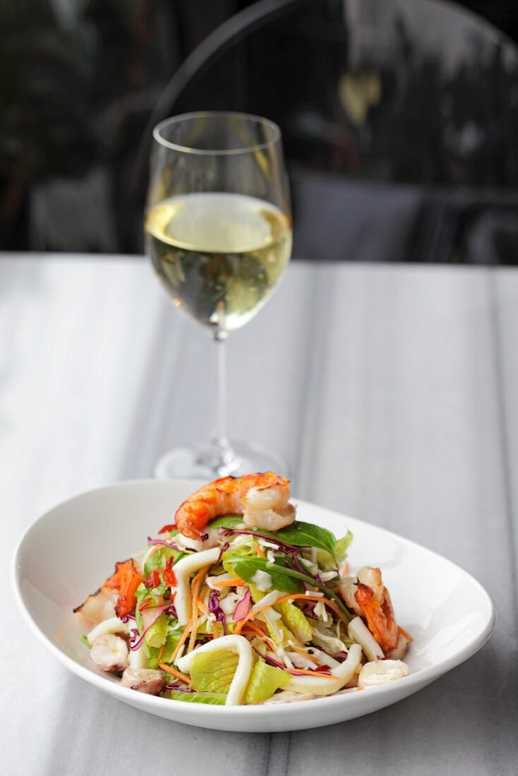 Seafood salad with a glass of white wine