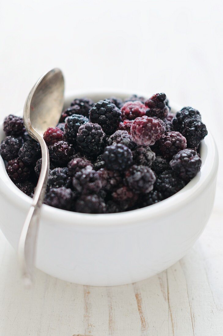 A small bowl of frozen blackberries