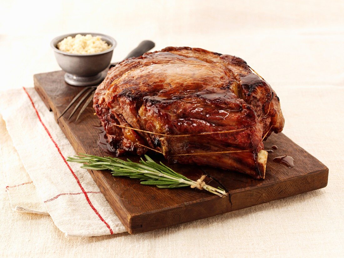 Roast beef and rosemary on a chopping board