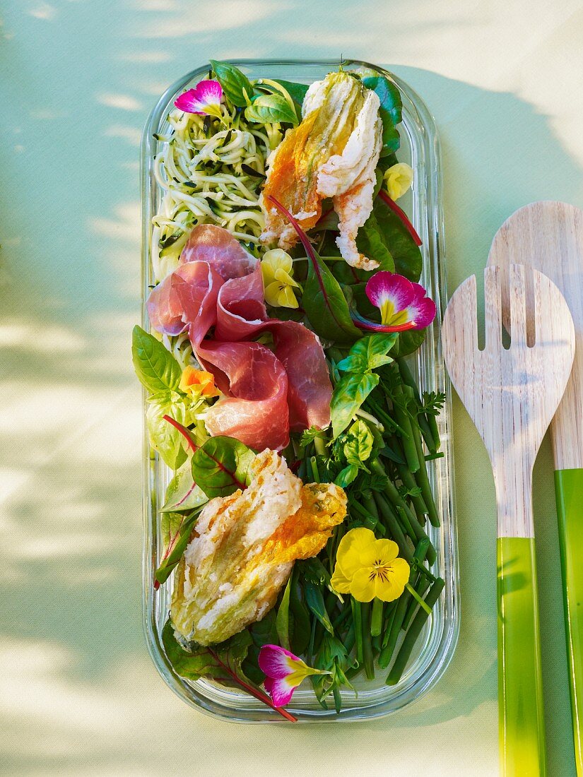 Vegetable salad with deep-fried courgette flowers and dry-cured ham