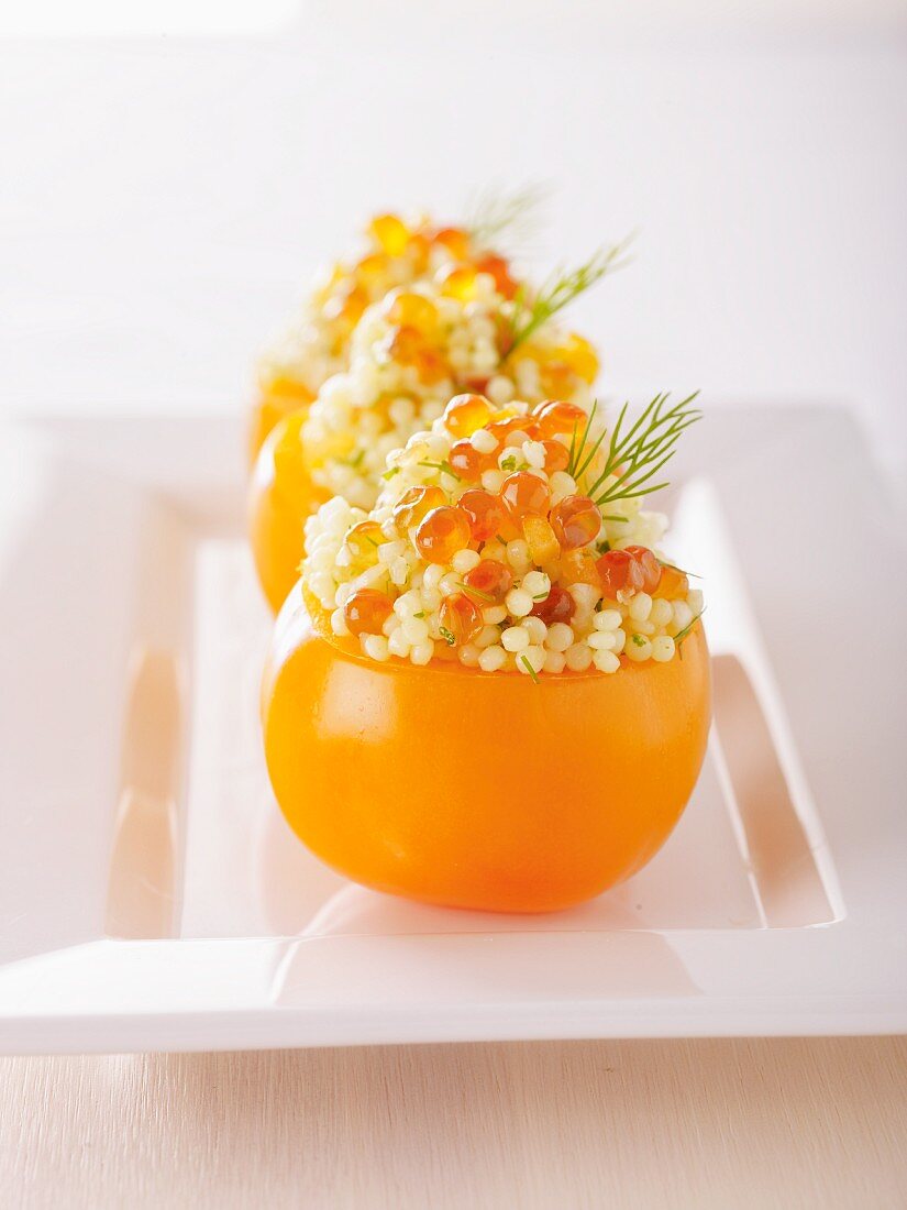 Yellow tomatoes filled with caviar and millet