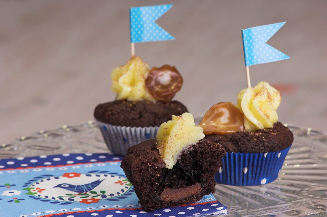 Chocolate cupcakes topped with vanilla icing and flags