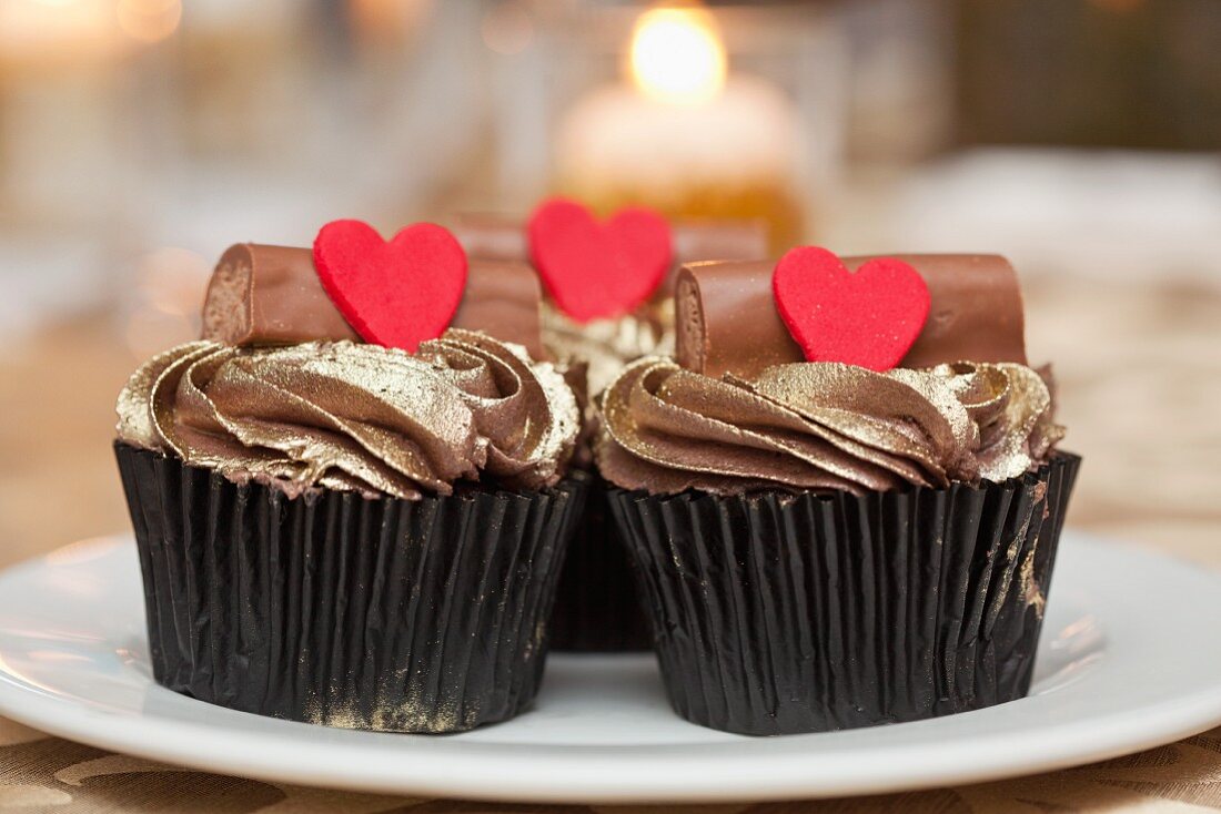 Cupcakes topped with gold icing and hearts