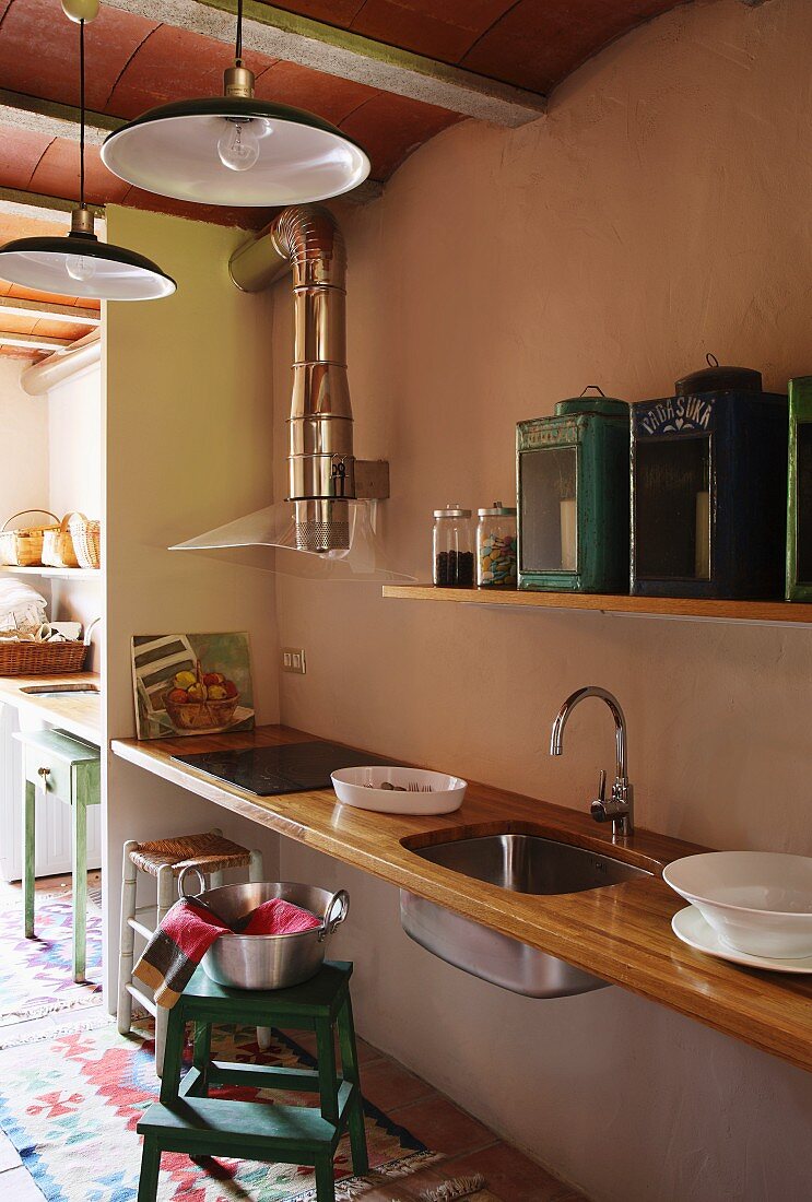 11155097 Simple Floating Kitchen Counter With Wooden Worksurface And Sink Mounted In Niche Below Vintage Lanterns On 