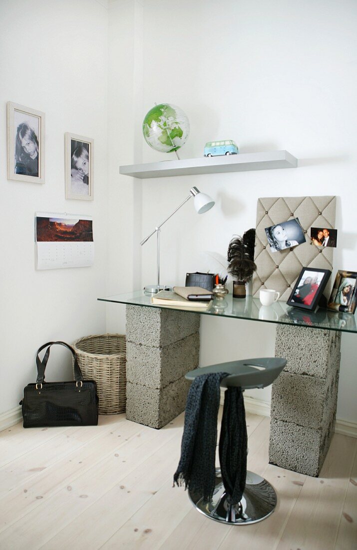 Improvised home office - glass table top on breeze blocks and designer stool in corner of room