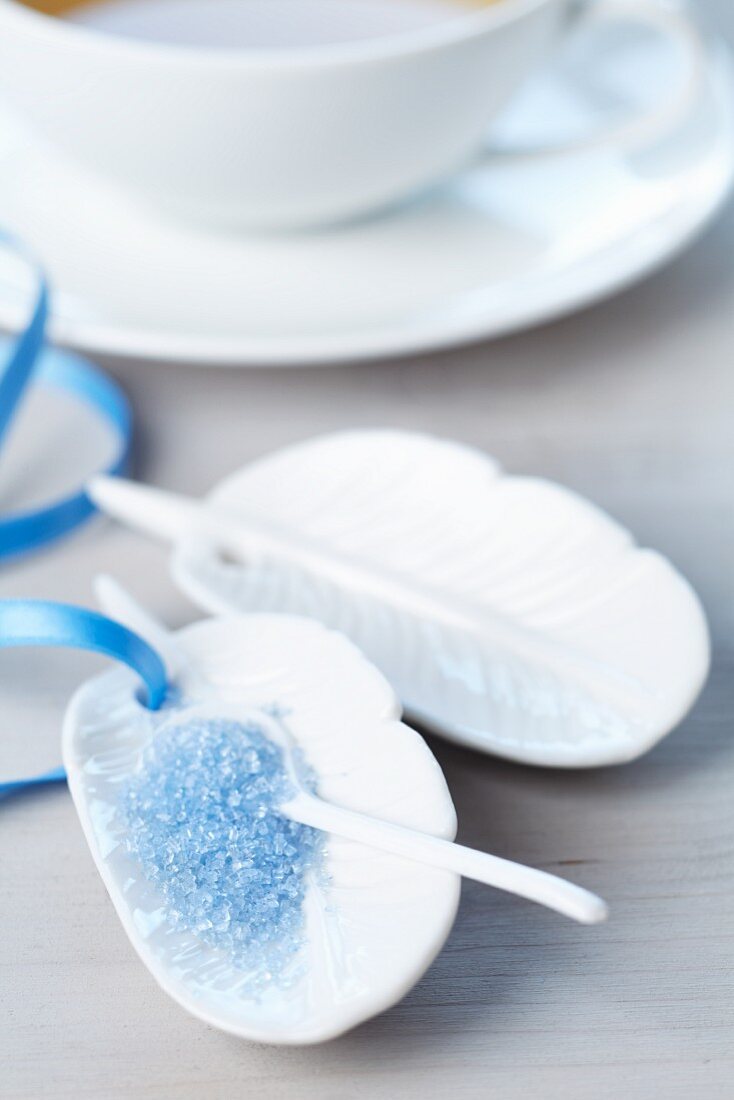 Small, feather-shaped plates with blue sugar
