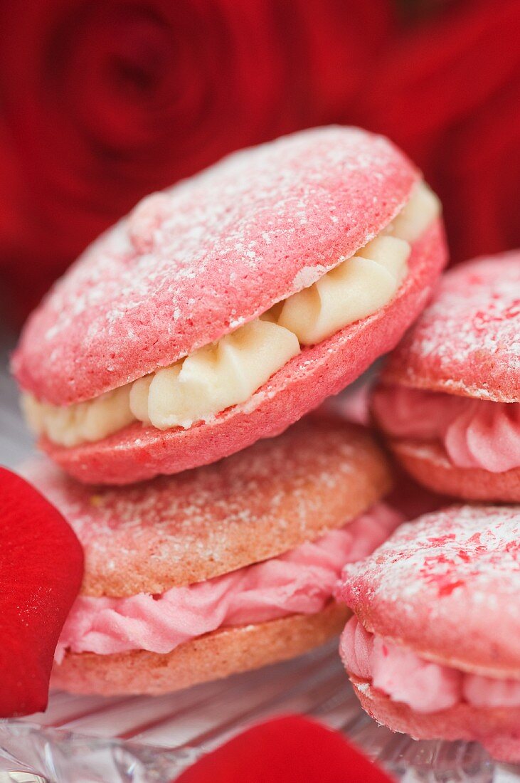 Strawberry and raspberry macaroons with buttercream filling and rose petals