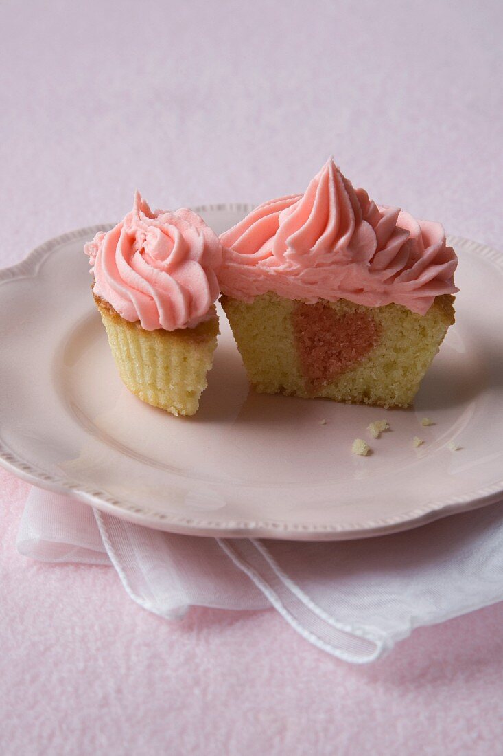 Vanilla Cupcake with a Pink Heart Center and Pink Frosting; Halved