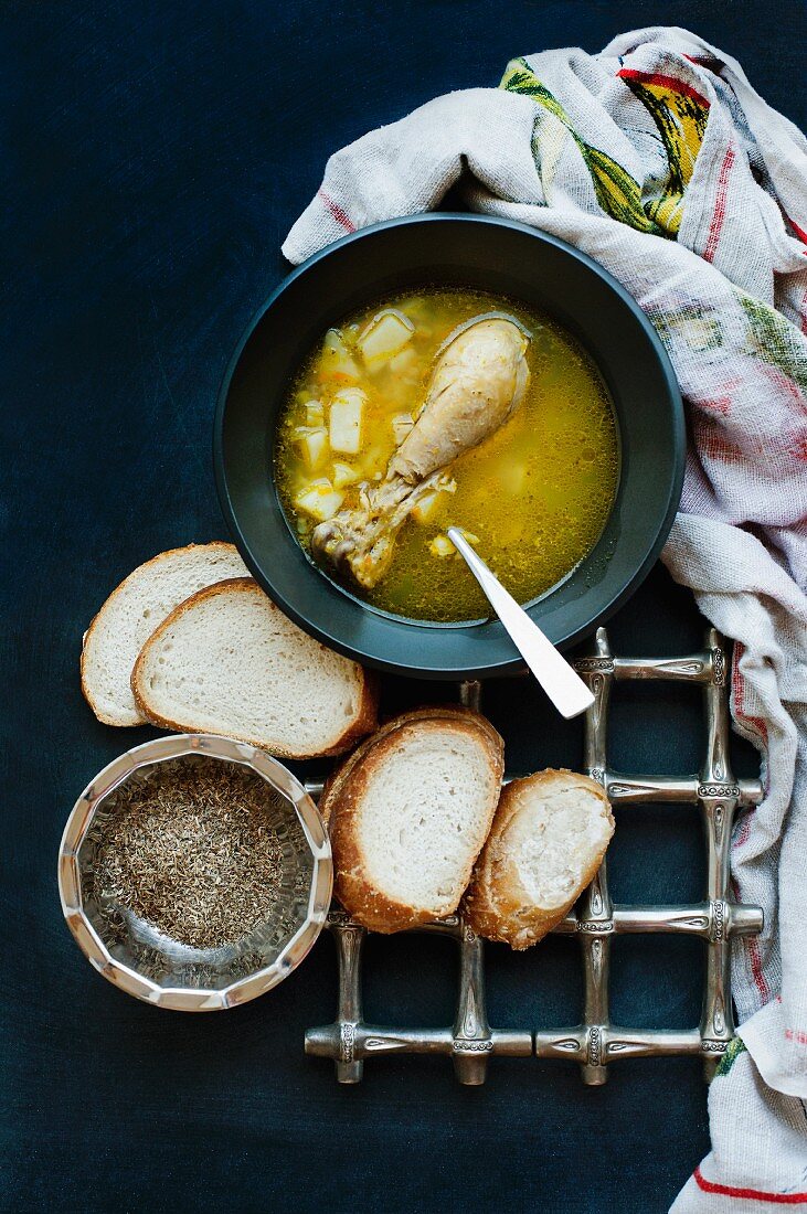 Chicken soup with white bread and pepper