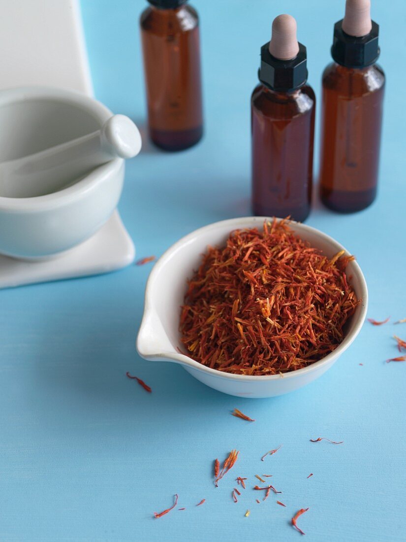 A Bowl of Saffron with Bottles of Saffron Extract