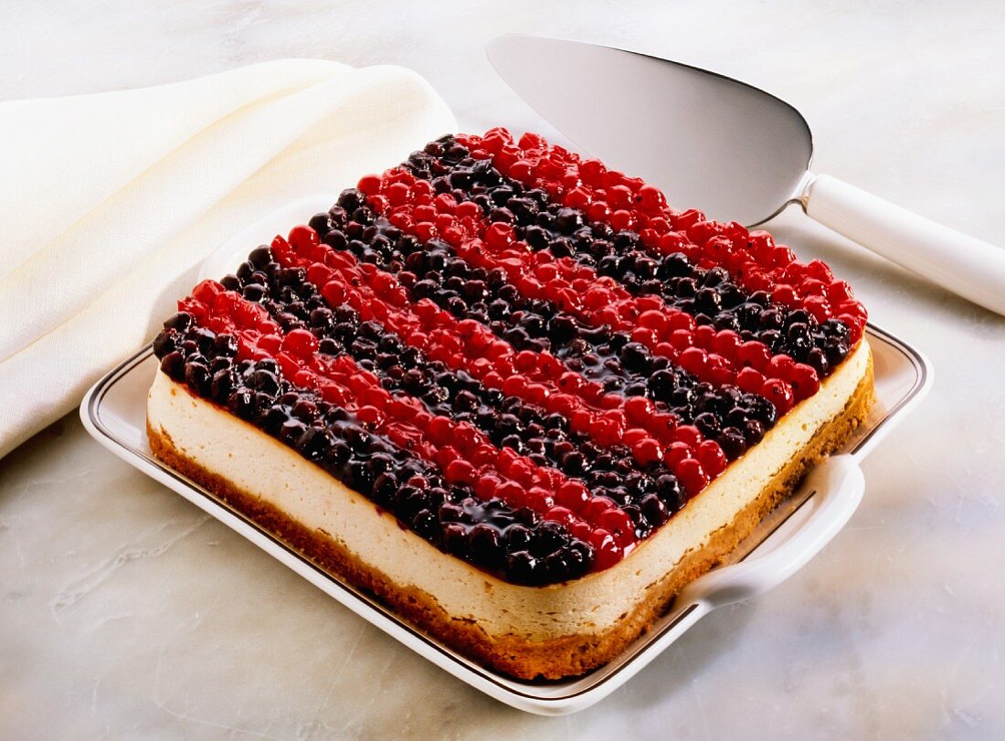 Cheesecake topped with blueberries and redcurrants