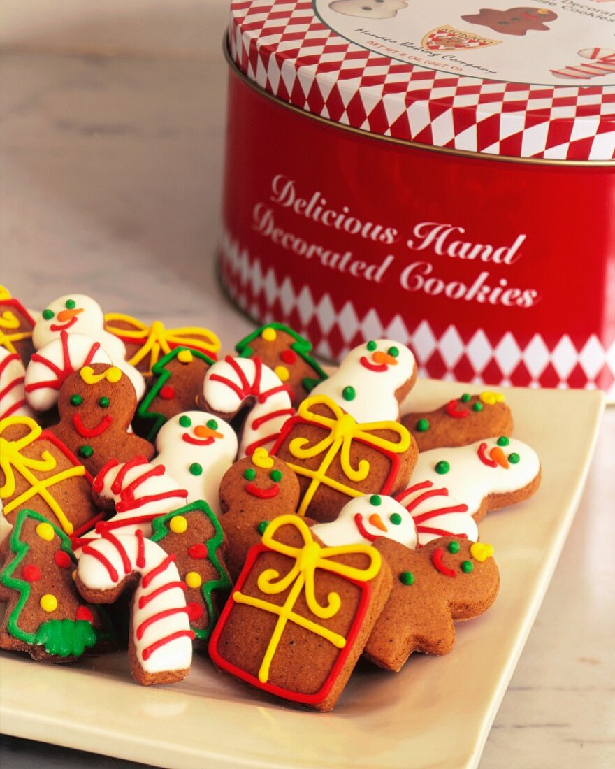 Assorted Decorated Christmas Cookies on a Platter with Cookie Tin in the Background