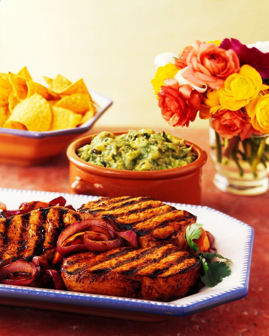 Grilled Boneless Pork Chops with Caramelized Onions; Guacamole and Tortilla Chips