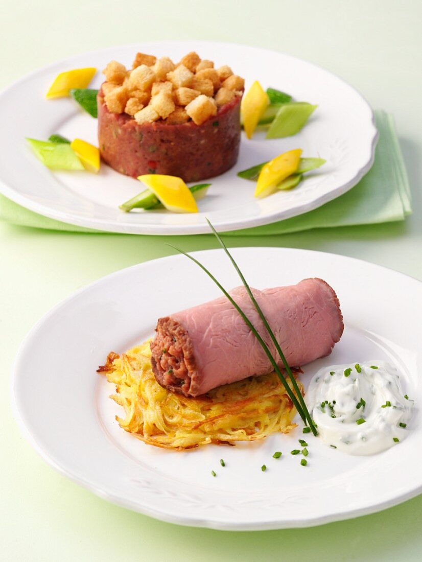 Filled, rolled roast beef sliced and a timbale of steak tartare with croutons