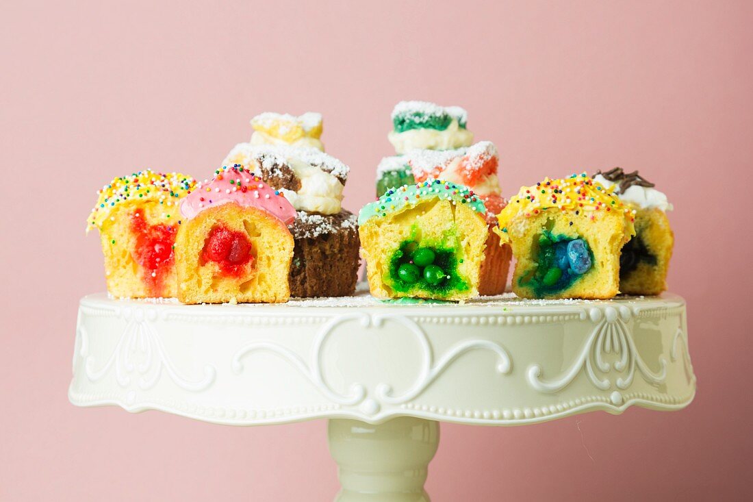 Assorted Filled Cupcakes; Halved to Show Fillings; On a Pedestal Dish