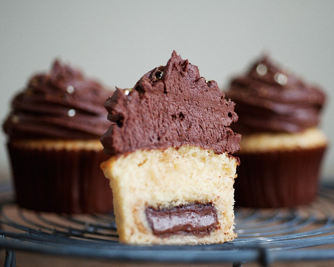 Filled cupcakes topped with chocolate cream