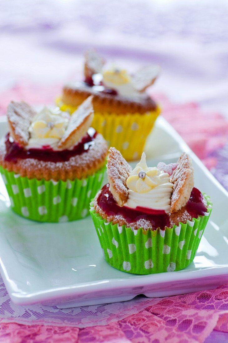 Cupcakes with raspberry jam and cream cheese topping