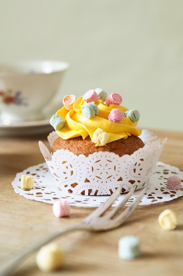 A cupcake topped with lemon icing